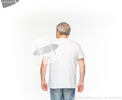 Image of Closeup of senior man\'s body in empty white t-shirt isolated on white background. Mock up for disign concept