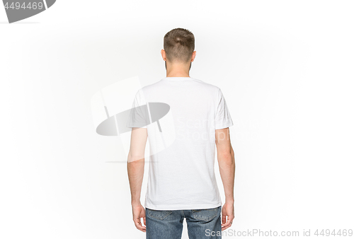 Image of Closeup of young man\'s body in empty white t-shirt isolated on white background. Mock up for disign concept