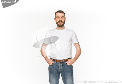 Image of Closeup of young man\'s body in empty white t-shirt isolated on white background. Mock up for disign concept