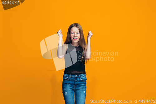 Image of Happy success teen girl celebrating being a winner. Dynamic energetic image of female model