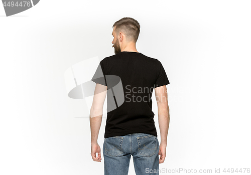 Image of Closeup of young man\'s body in empty black t-shirt isolated on white background. Mock up for disign concept