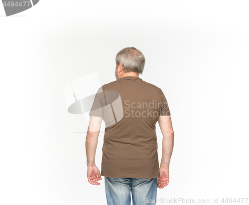 Image of Closeup of senior man\'s body in empty brown t-shirt isolated on white background. Mock up for disign concept