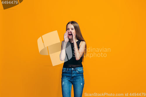 Image of Isolated on yellow young casual teen girl shouting at studio