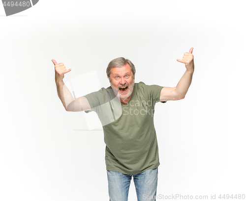 Image of Closeup of senior man\'s body in empty green t-shirt isolated on white background. Mock up for disign concept