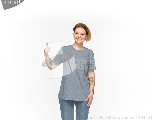 Image of Closeup of young woman\'s body in empty gray t-shirt isolated on white background. Mock up for disign concept