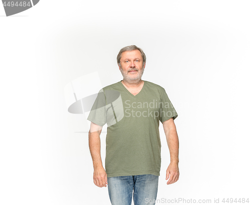 Image of Closeup of senior man\'s body in empty green t-shirt isolated on white background. Mock up for disign concept