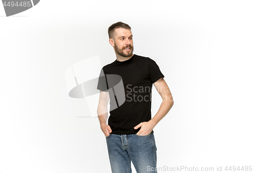 Image of Closeup of young man\'s body in empty black t-shirt isolated on white background. Mock up for disign concept