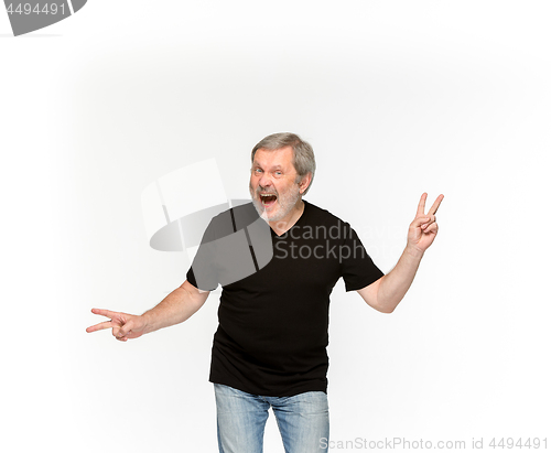 Image of Closeup of senior man\'s body in empty black t-shirt isolated on white background. Mock up for disign concept