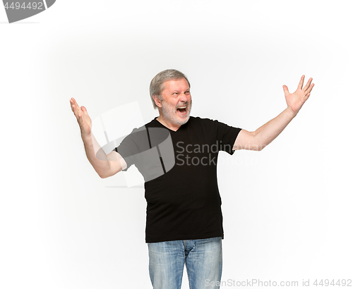 Image of Closeup of senior man\'s body in empty black t-shirt isolated on white background. Mock up for disign concept