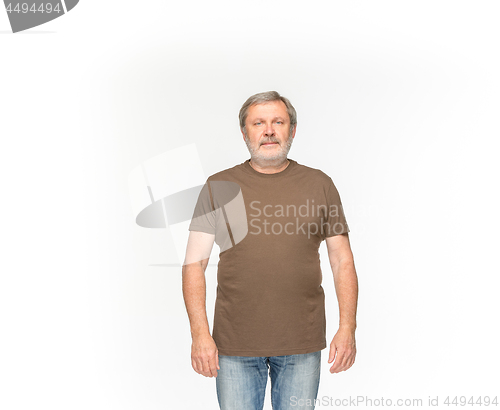 Image of Closeup of senior man\'s body in empty brown t-shirt isolated on white background. Mock up for disign concept