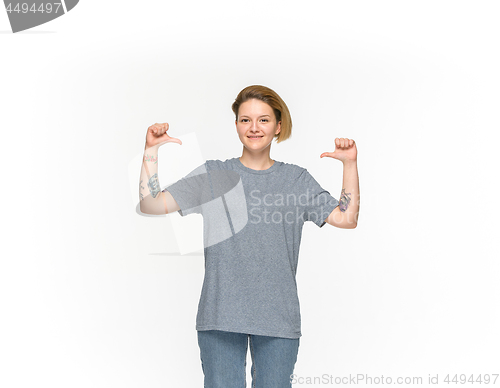 Image of Closeup of young woman\'s body in empty gray t-shirt isolated on white background. Mock up for disign concept