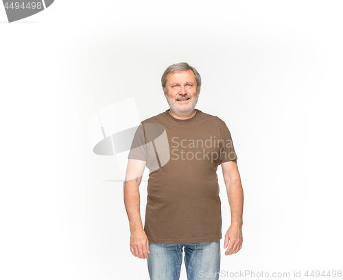 Image of Closeup of senior man\'s body in empty brown t-shirt isolated on white background. Mock up for disign concept