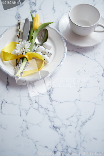 Image of Spring Easter Table setting at white marble table. Top view