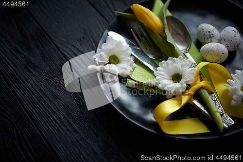 Image of Easter spring table dishware composition with yellow tulip flower
