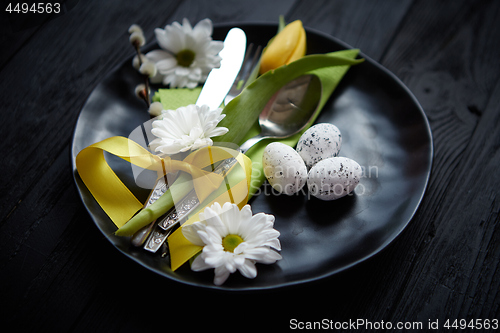 Image of Easter spring table dishware composition with yellow tulip flower