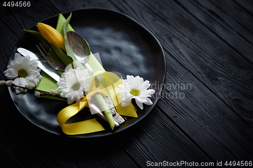 Image of Easter spring table dishware composition with yellow tulip flower