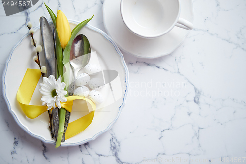 Image of Spring Easter Table setting at white marble table. Top view