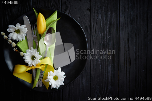 Image of Easter spring table dishware composition with yellow tulip flower