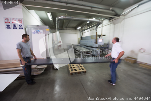 Image of workers in a factory of wooden furniture