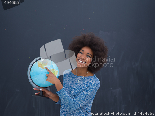 Image of black woman holding Globe of the world