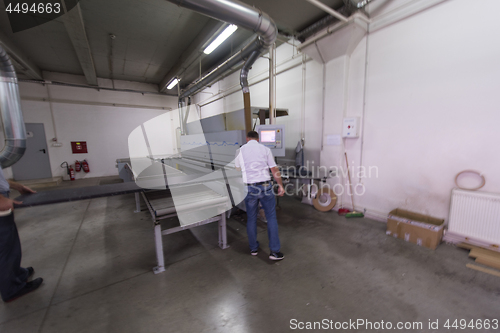 Image of workers in a factory of wooden furniture