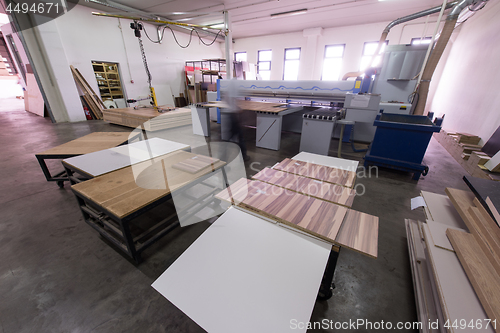 Image of worker in a factory of wooden furniture