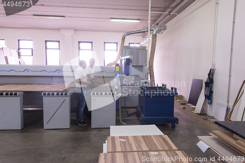 Image of workers in a factory of wooden furniture