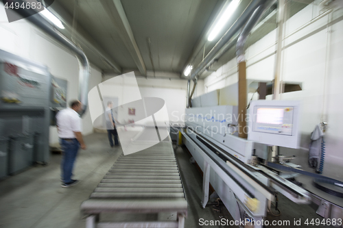 Image of workers in a factory of wooden furniture