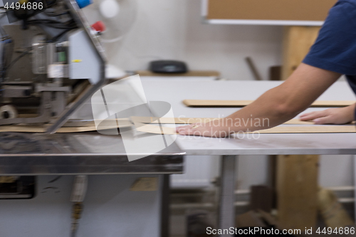 Image of engineer in front of wood cutting machine