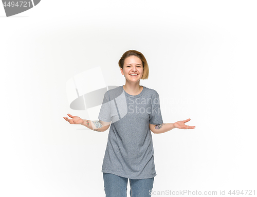 Image of Closeup of young woman\'s body in empty gray t-shirt isolated on white background. Mock up for disign concept