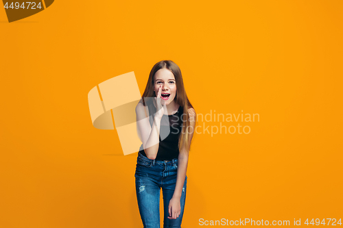 Image of Isolated on yellow young casual teen girl shouting at studio