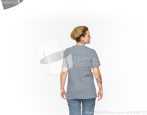 Image of Closeup of young woman\'s body in empty gray t-shirt isolated on white background. Mock up for disign concept