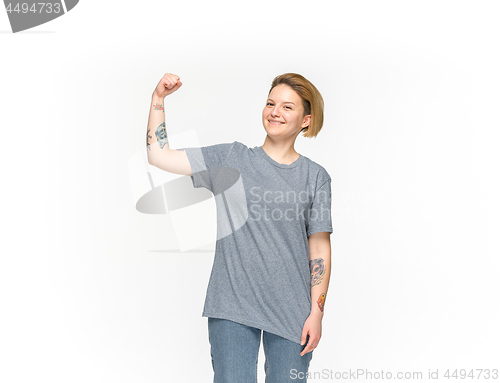 Image of Closeup of young woman\'s body in empty gray t-shirt isolated on white background. Mock up for disign concept