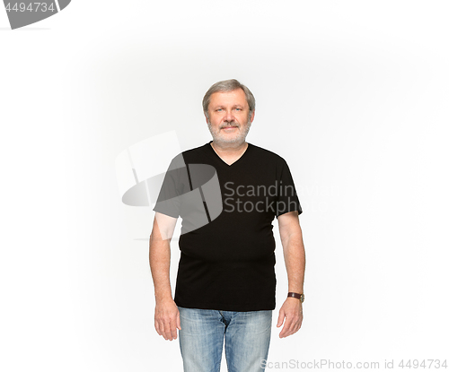 Image of Closeup of senior man\'s body in empty black t-shirt isolated on white background. Mock up for disign concept