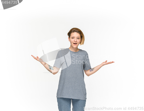 Image of Closeup of young woman\'s body in empty gray t-shirt isolated on white background. Mock up for disign concept