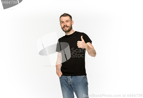 Image of Closeup of young man\'s body in empty black t-shirt isolated on white background. Mock up for disign concept