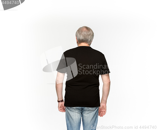 Image of Closeup of senior man\'s body in empty black t-shirt isolated on white background. Mock up for disign concept