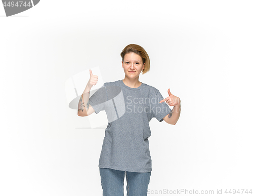 Image of Closeup of young woman\'s body in empty gray t-shirt isolated on white background. Mock up for disign concept
