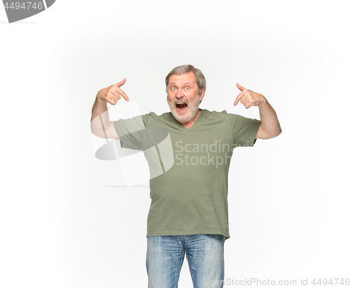 Image of Closeup of senior man\'s body in empty green t-shirt isolated on white background. Mock up for disign concept