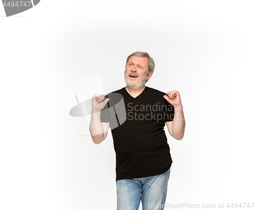 Image of Closeup of senior man\'s body in empty black t-shirt isolated on white background. Mock up for disign concept