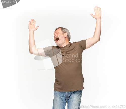 Image of Closeup of senior man\'s body in empty brown t-shirt isolated on white background. Mock up for disign concept