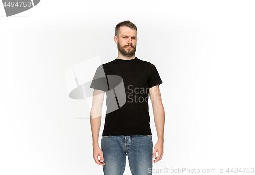 Image of Closeup of young man\'s body in empty black t-shirt isolated on white background. Mock up for disign concept