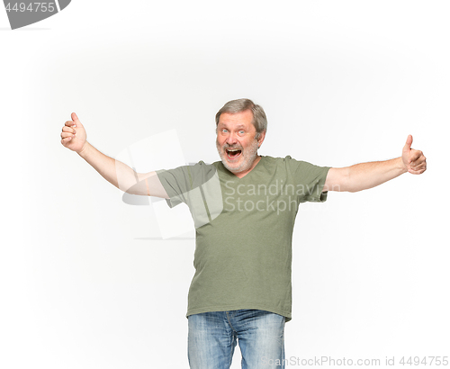 Image of Closeup of senior man\'s body in empty green t-shirt isolated on white background. Mock up for disign concept