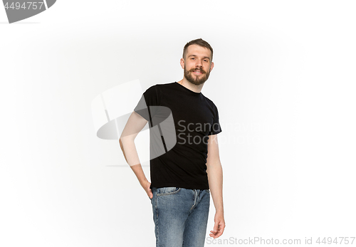 Image of Closeup of young man\'s body in empty black t-shirt isolated on white background. Mock up for disign concept