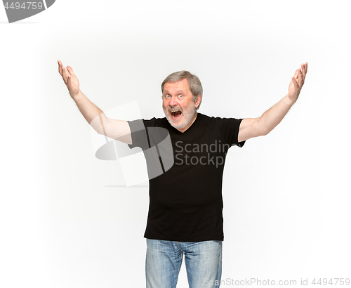 Image of Closeup of senior man\'s body in empty black t-shirt isolated on white background. Mock up for disign concept