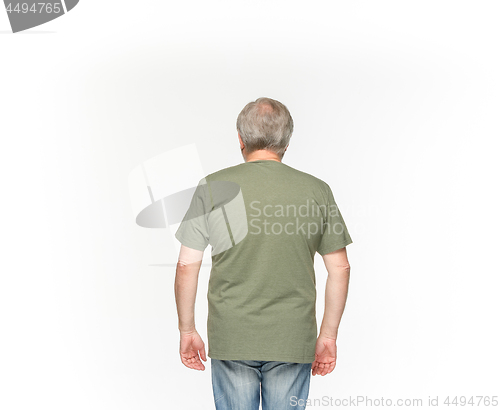 Image of Closeup of senior man\'s body in empty green t-shirt isolated on white background. Mock up for disign concept
