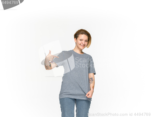 Image of Closeup of young woman\'s body in empty gray t-shirt isolated on white background. Mock up for disign concept