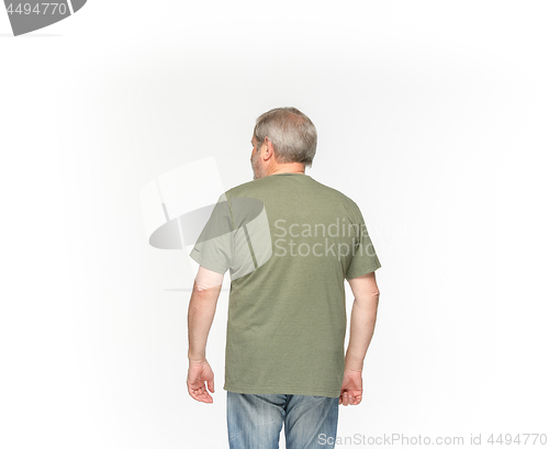 Image of Closeup of senior man\'s body in empty green t-shirt isolated on white background. Mock up for disign concept