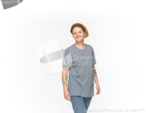 Image of Closeup of young woman\'s body in empty gray t-shirt isolated on white background. Mock up for disign concept