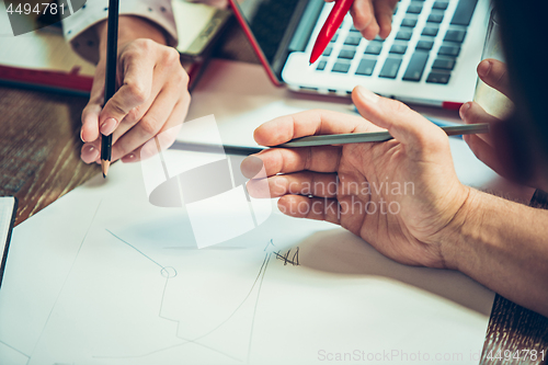 Image of The hands of people working at office